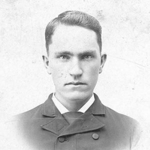 White man in suit and tie and overcoat
