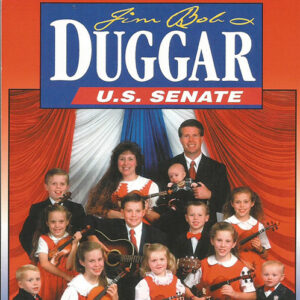 White man in suit and woman in dress with children holding musical instruments below "Jim Bob Duggar U.S. Senate" banner