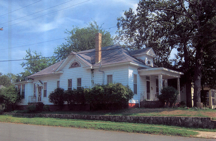 Side view of house with white siding and covered porch on street