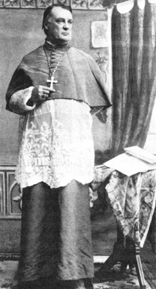 White man in bishop's robes with cross necklace