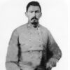 Portrait of a white man with short dark hair and goatee in a military uniform.