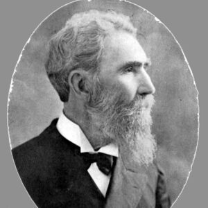 Profile view of old white man with long beard in suit and tie