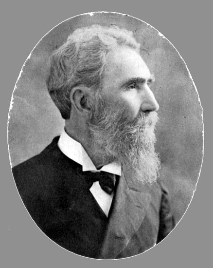 Profile view of old white man with long beard in suit and tie