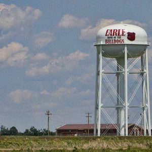 Tall white "Earle Home of the Bulldogs" water tower and buildings