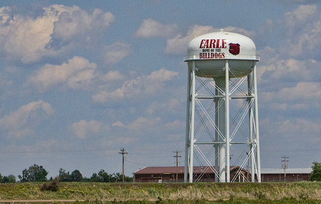 Tall white "Earle Home of the Bulldogs" water tower and buildings