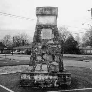 Stone monument with plaque in residential area
