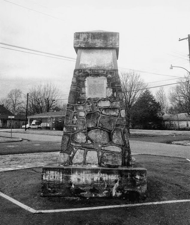 Stone monument with plaque in residential area