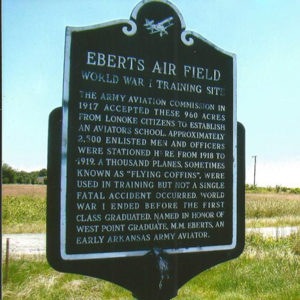 "Eberts Air Field" sign in a field by a gravel road