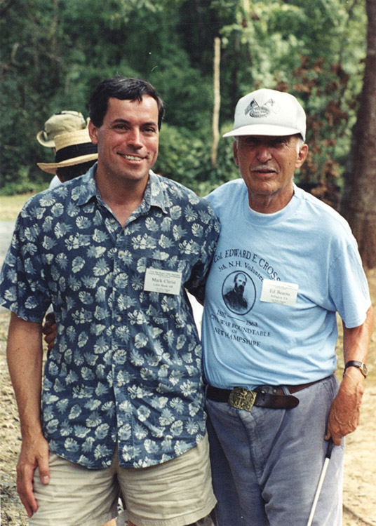 White man smiling in Hawaiian shirt with older white man in T-shirt and hat