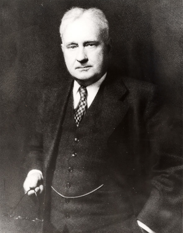 White man standing in suit and tie
