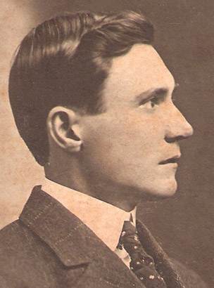 Profile view of white man in suit and tie