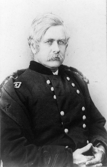 White man with mustache sitting in military uniform