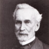 white man with white beard in suit