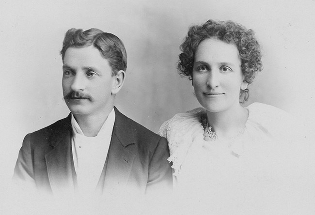 Portrait of white man in suit and white woman with curly hair in dress