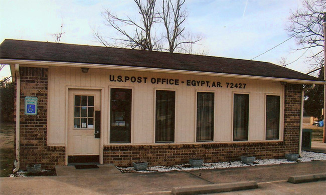 Single-story brick building with parking lot "U.S. Post Office Egypt"