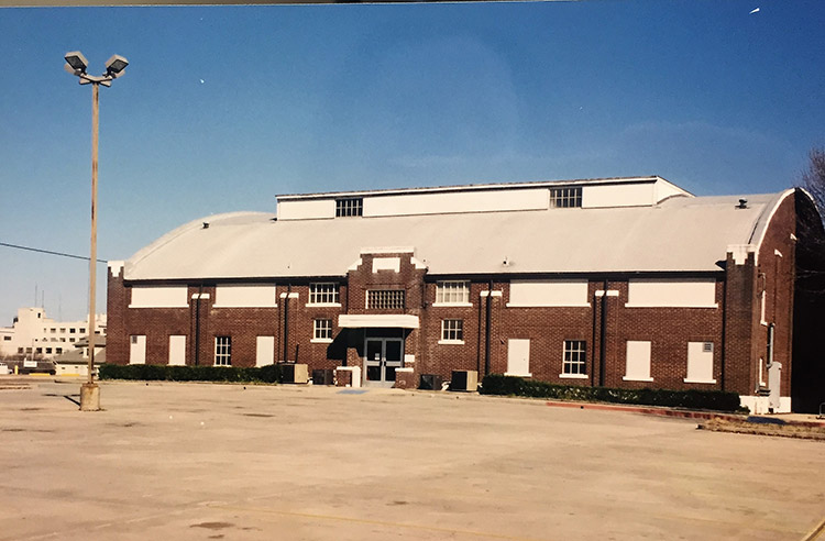 Brick gymnasium building with rounded roof and skylight