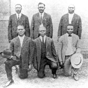 Group of seven African-American men in suits posing