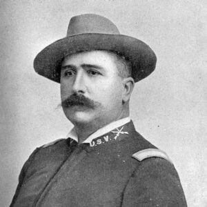 White man with hat and mustache in military uniform