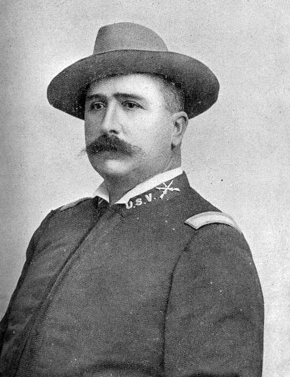 White man with hat and mustache in military uniform