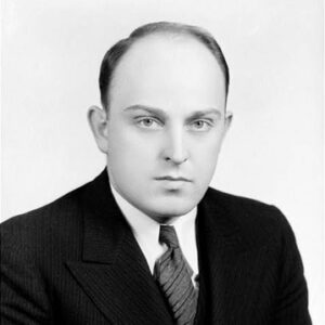 Balding white man in suit with striped tie