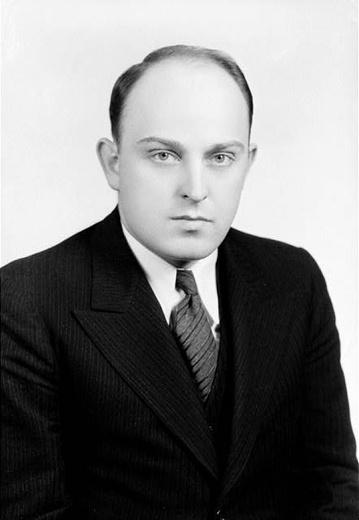 Balding white man in suit with striped tie