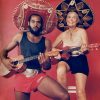 African-American man and white woman with ukuleles and sombrero hats