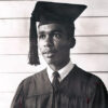 Young African-American man in graduation robe with cap