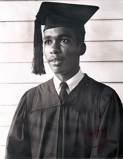 Young African-American man in graduation robe with cap