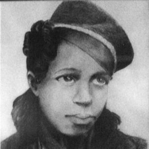 Young African-American woman in hat and coat