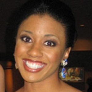 Young Black woman smiling in dress and earrings