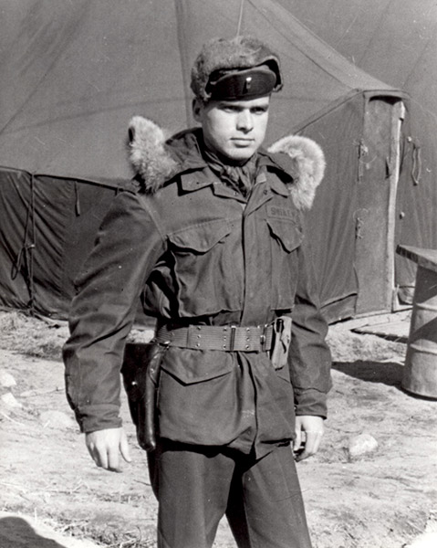 White man in military coat with fur shoulder pads and tent