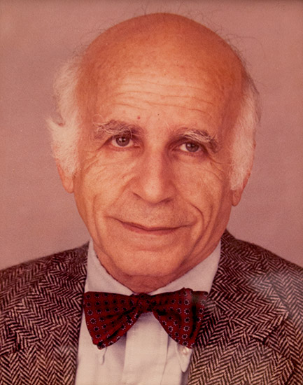 Bald white man in suit with red bow tie