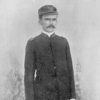 White man with mustache in military uniform with cap