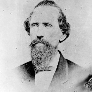 White man with beard and mustache in suit with bow tie