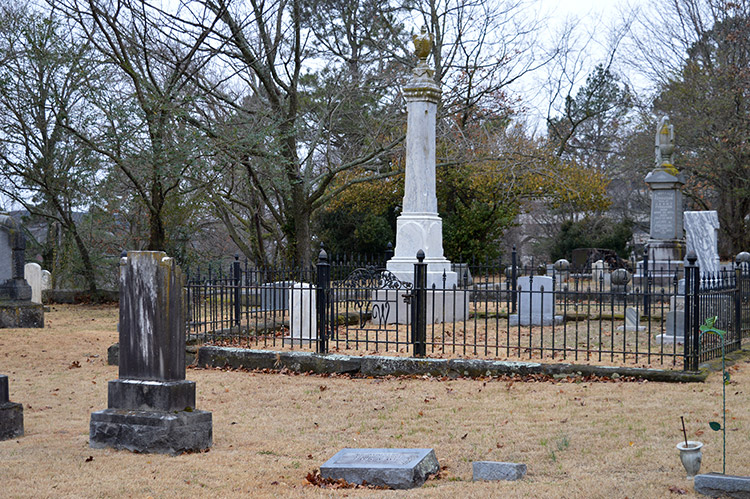 Family plot in cemetery with iron fence