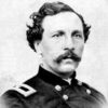 White man with mustache and wavy hair in military uniform