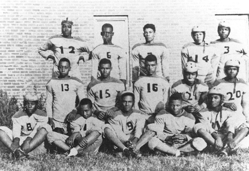 Group of young African-American men in matching football uniforms