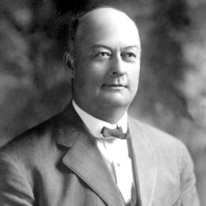 Bald white man in suit and bow tie