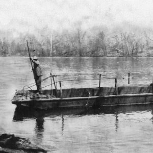 White man operating ferry on river