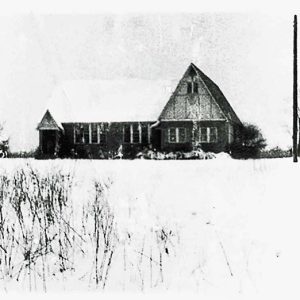 house with A-frame roof in snow covered field