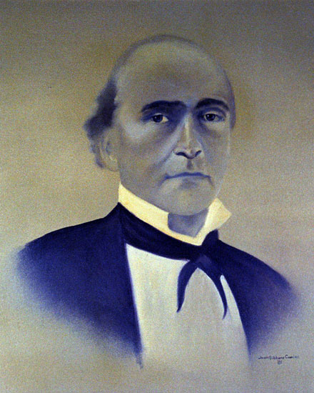 Bald white man in black suit and white shirt and bow tie