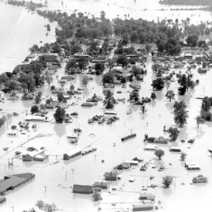 Aerial view of flooded neighborhood alongside river
