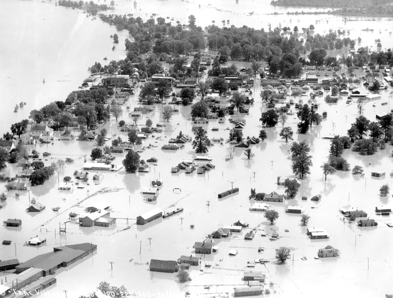 Aerial view of flooded neighborhood alongside river