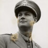 Portrait white male U S Army officer with medal of honor smiling gazing off into distance