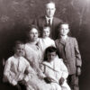 formal portrait of white man and woman with four children