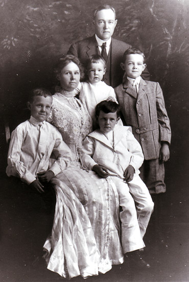 formal portrait of white man and woman with four children