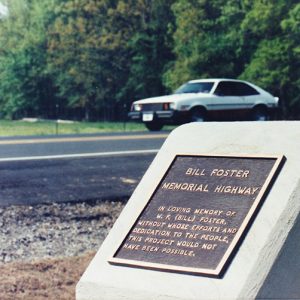 "Bill Foster Memorial Highway" plaque on monument next to highway