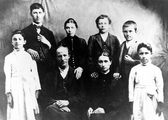 White man woman and children in family photograph