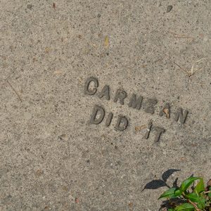 "Carmean did it" imprint on sidewalk