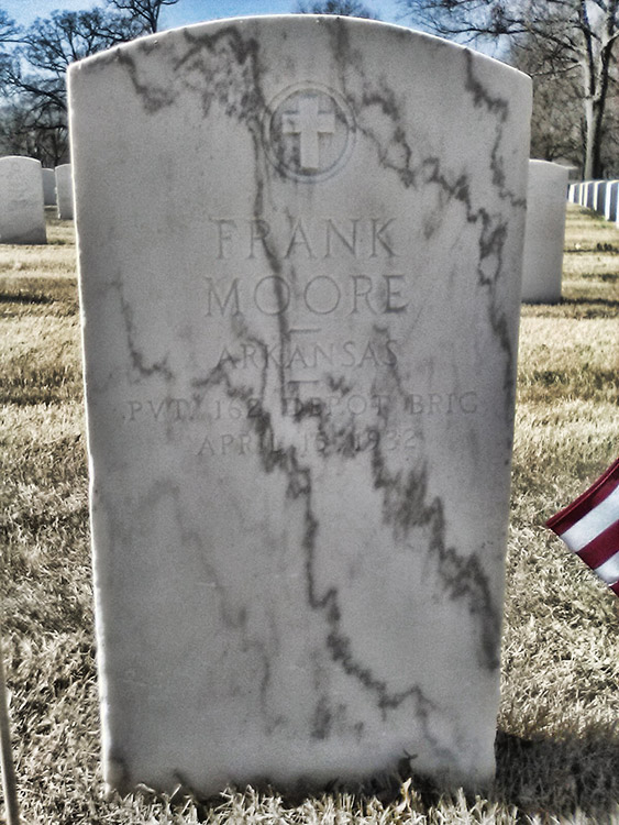 White marble gravestone with cross and "Frank Moore" engraving